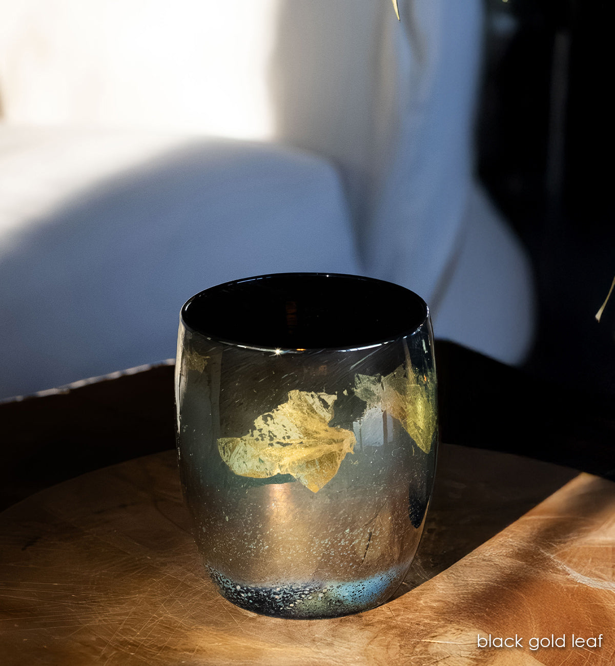 'black gold leaf', 14k gold leaf dancing across deep black glass handblown glass candle holder.