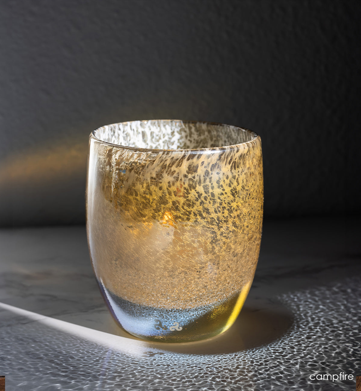 campfire, gold speckled glassybaby, hand-blown glass candle holder shimmering in the light.