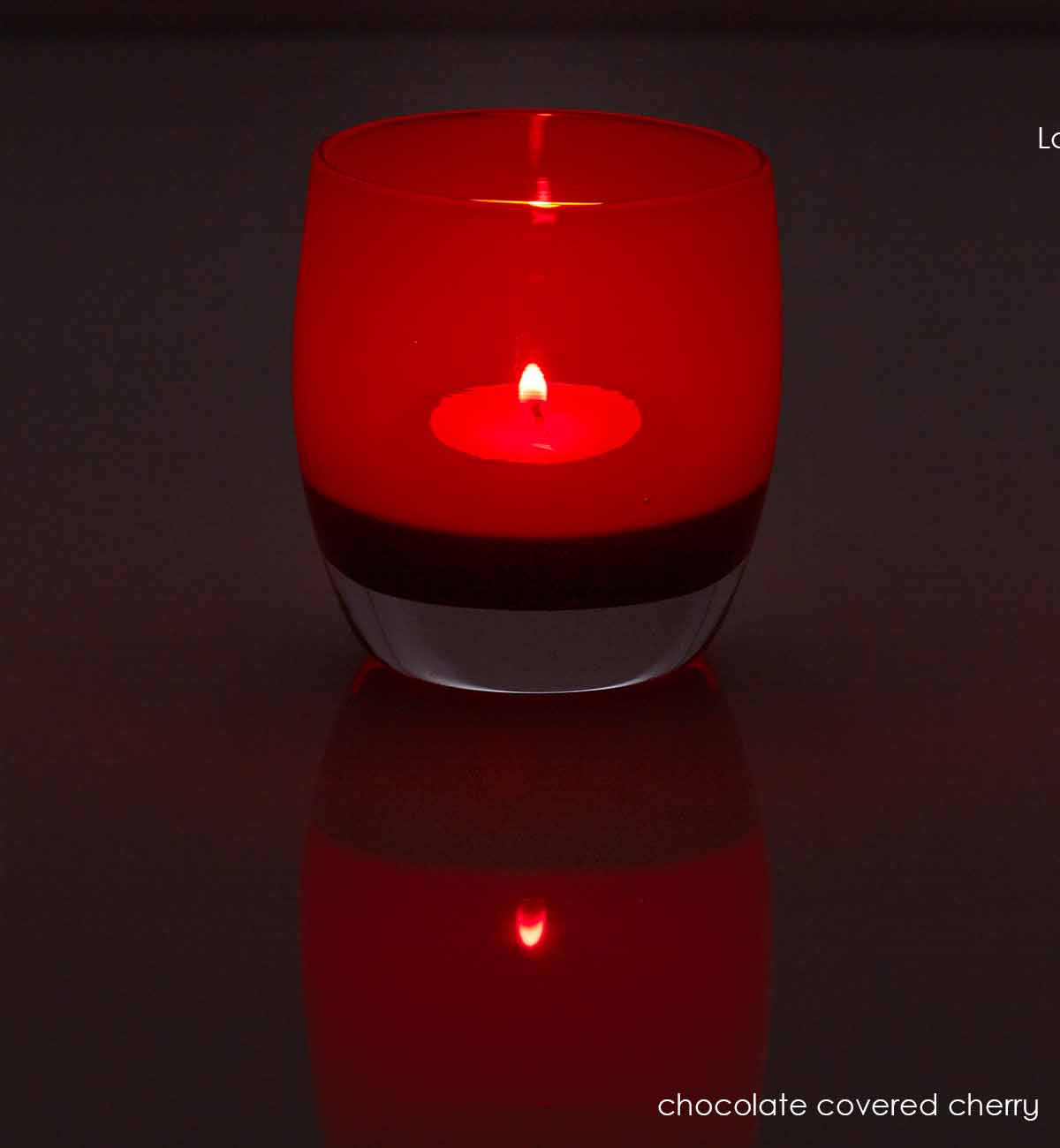 chocolate covered cherry, translucent red brown hand-blown glass votive candle holder. light by candle light.