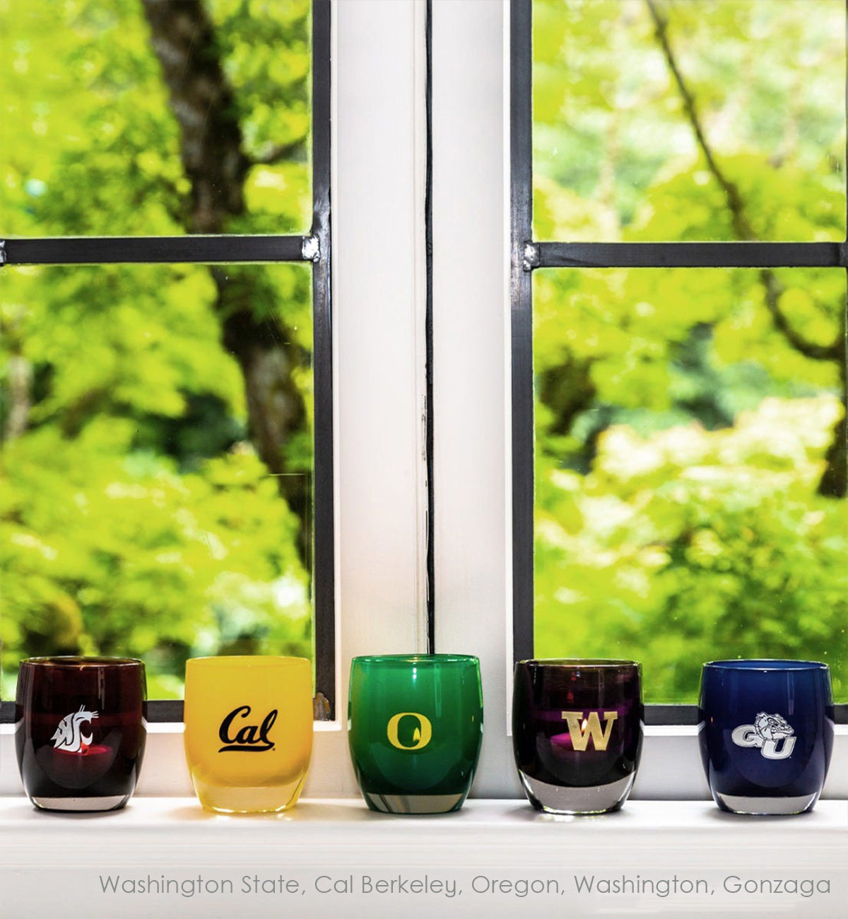 collegiate collection on a windowsill featuring WSU, Cal, UO, UW, and Gonzaga hand-blown glass votive candle holders.