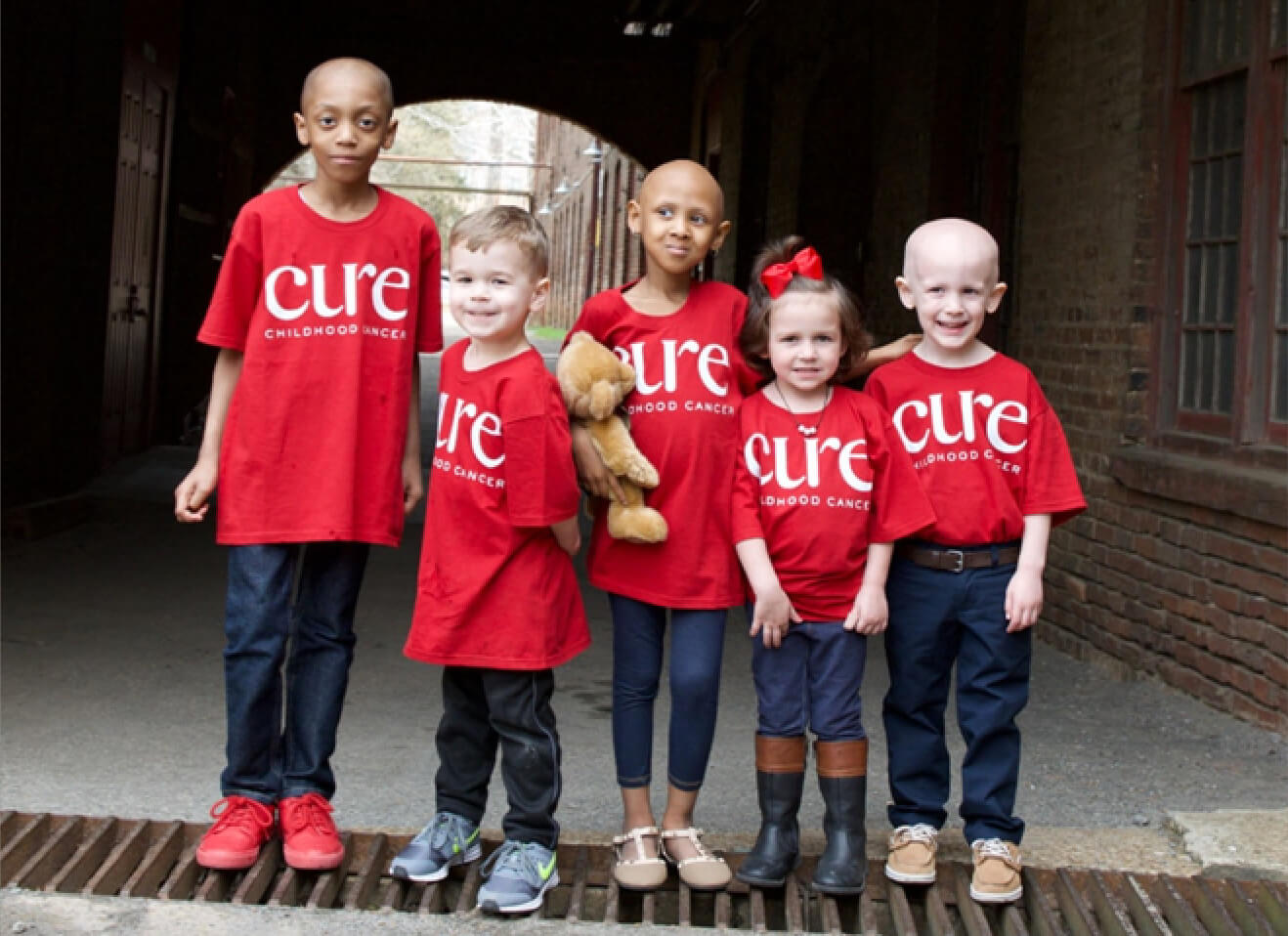 children wearing red "cure" shirts