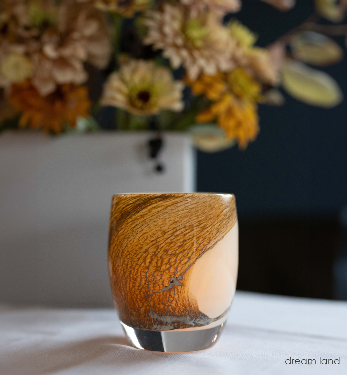 dream land, cream with brown textured swirls hand-blown glass votive glassybaby  with fall flowers in the background.