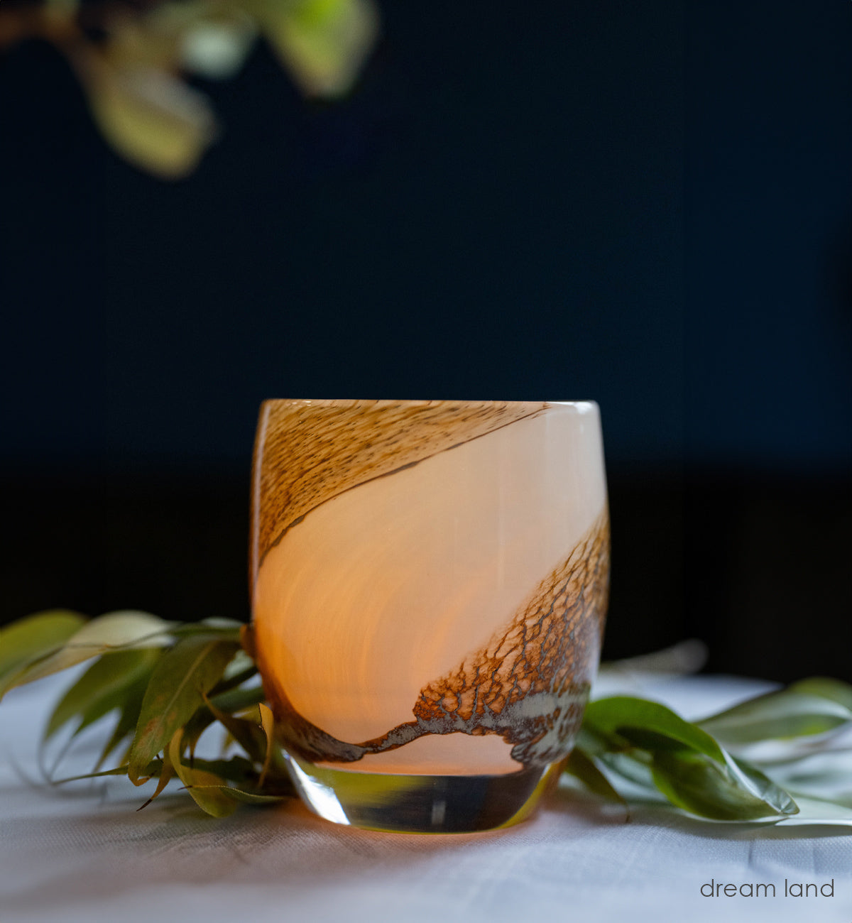 dream land, cream with brown textured swirls hand-blown glass votive glassybaby  with fall flowers in the background.