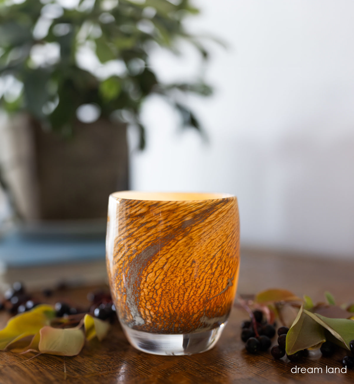 dream land, cream with brown textured swirls hand-blown glass votive glassybaby  with fall flowers in the background.