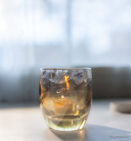 clear with gold, and gray marks on handblown glass candle holder. 