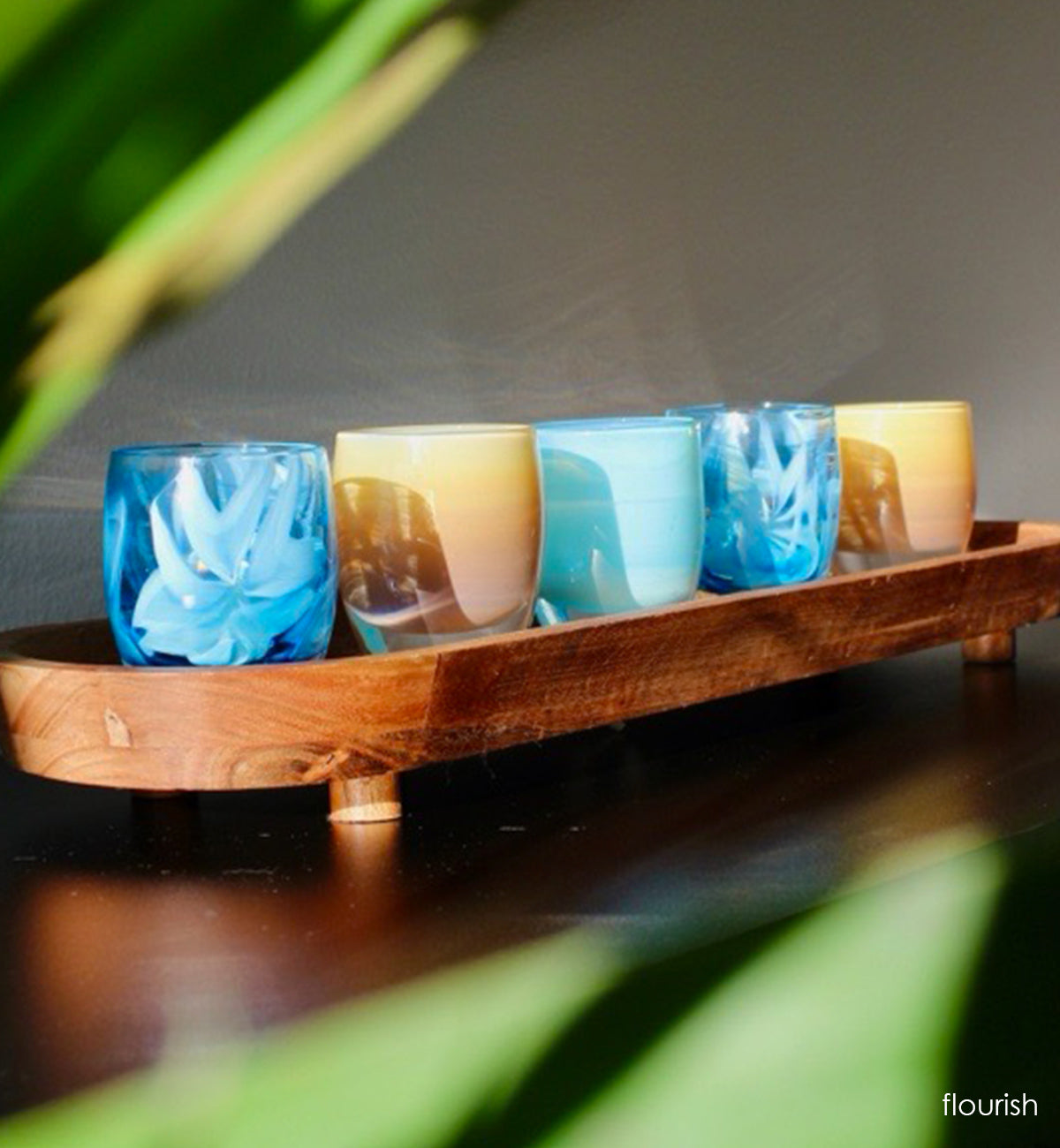 'flourish' is adorned with blue murrini flowers hand-crafted glass votive candle holders with tan and light blue  candle holders