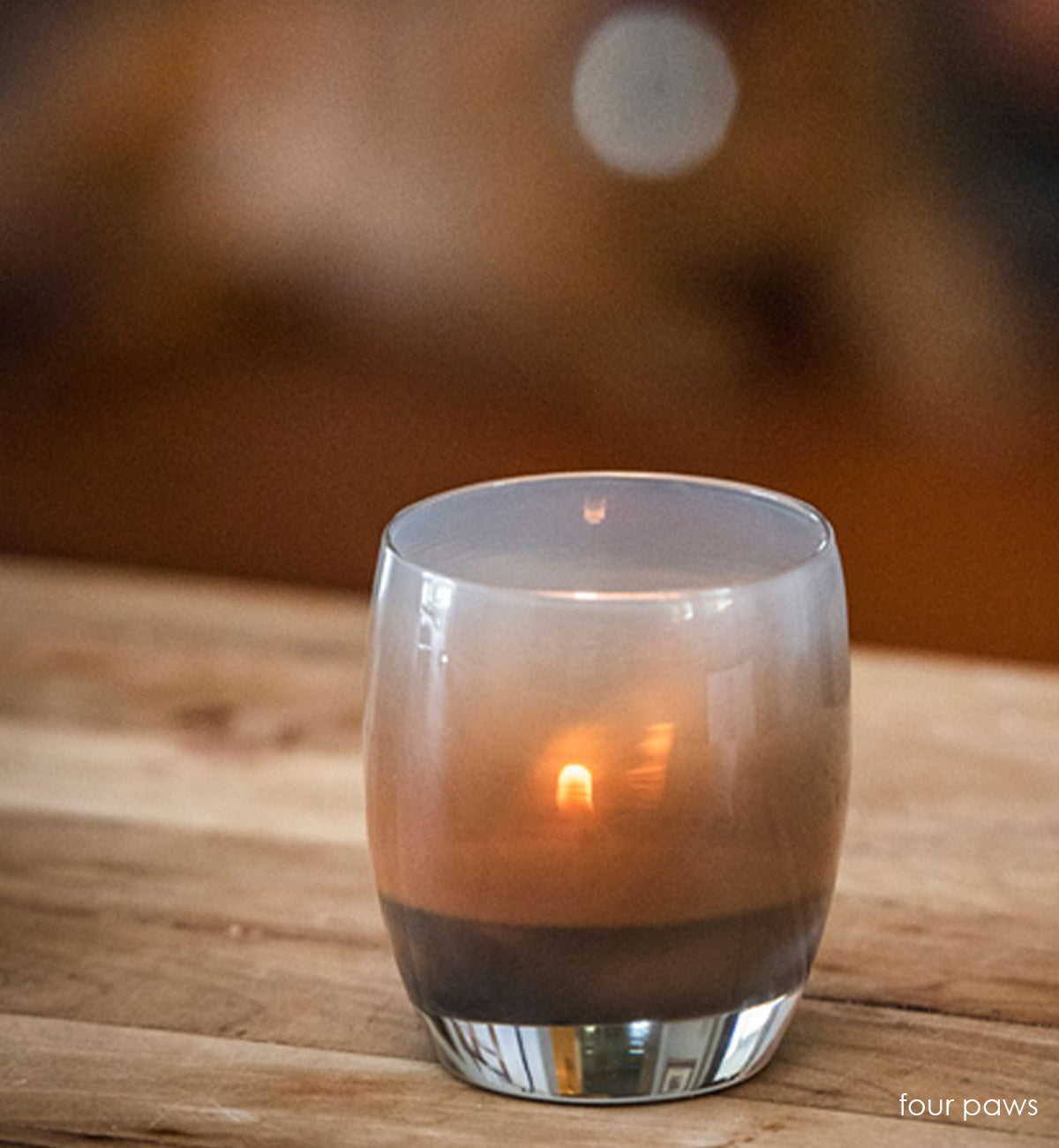 four paws smokey gray hand-blown glass votive candle holder.