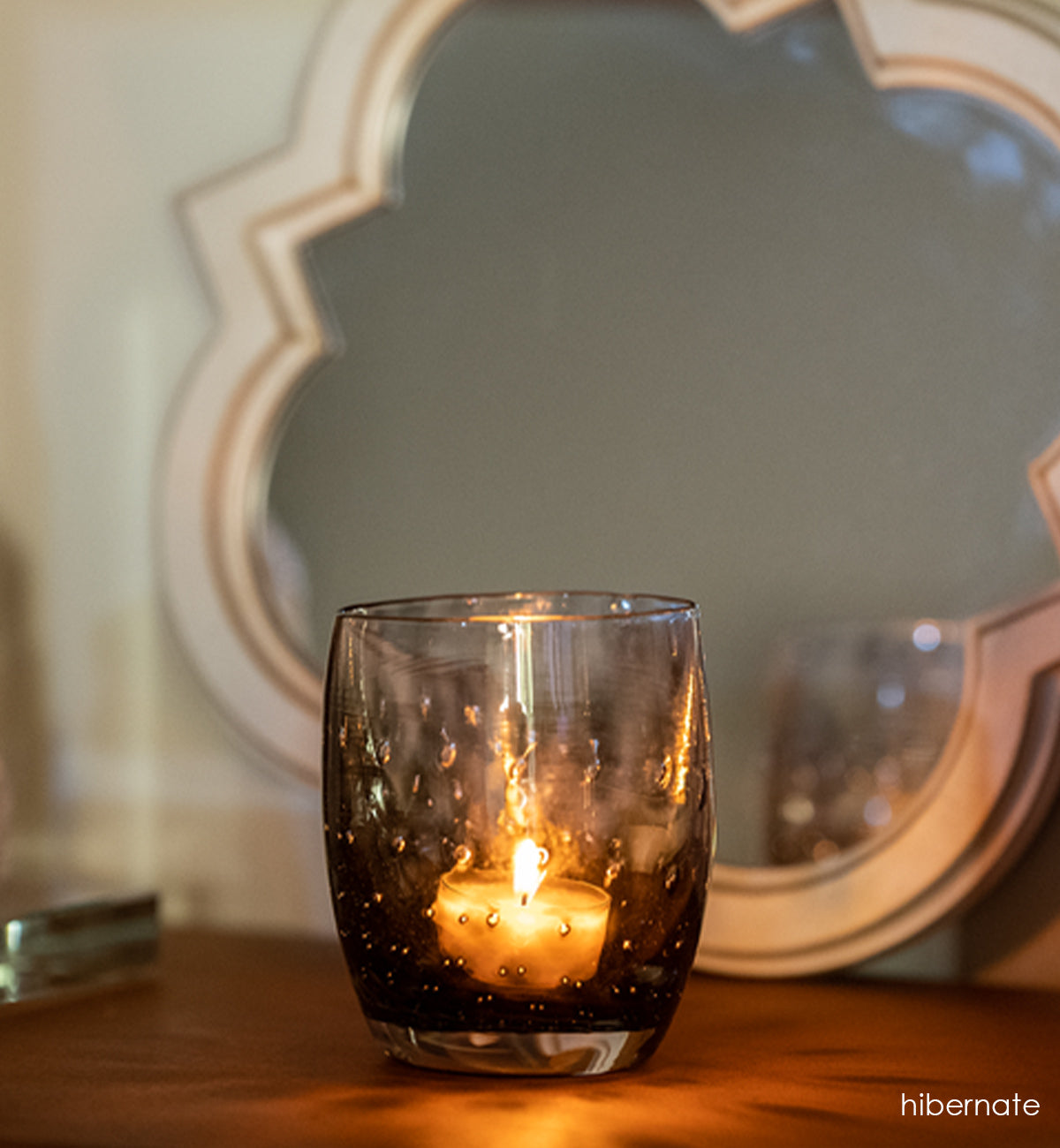 smokey grey hand-blown glass candle holder with a beautiful bubble pattern.