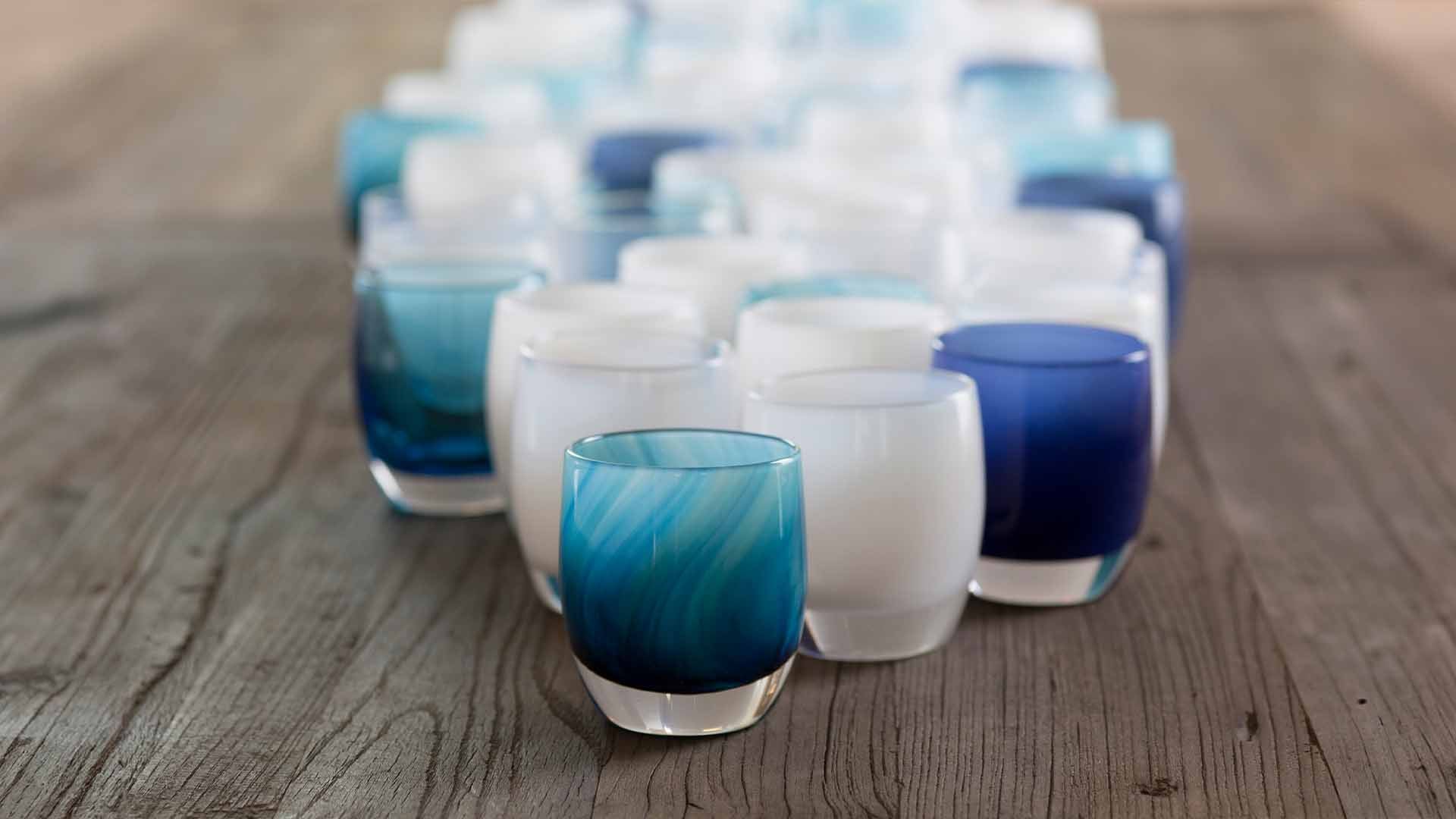'home run' blue white swirl hand-blown glass votive candle holder on a wooden table. Paired with hope, forever, blue eyes, and cherish. 