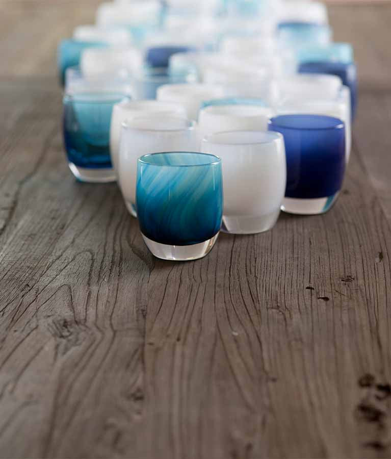 'home run' blue white swirl hand-blown glass votive candle holder on a wooden table. Paired with hope, forever, blue eyes, and cherish.