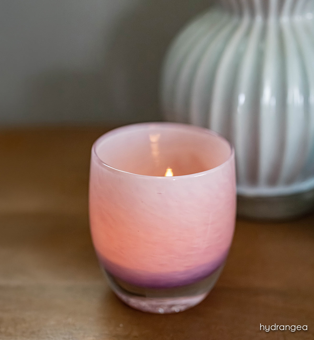 hydrangea | pink with purple ombré hand-blown glass candle holder with a blurred vase in the background