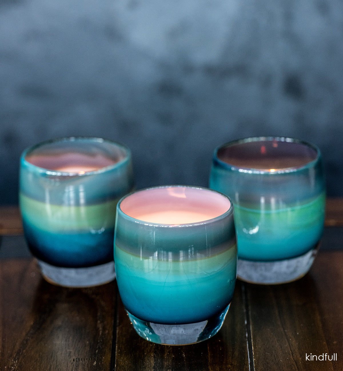 kindfull hand-blown teal with red flame glass candle holder.