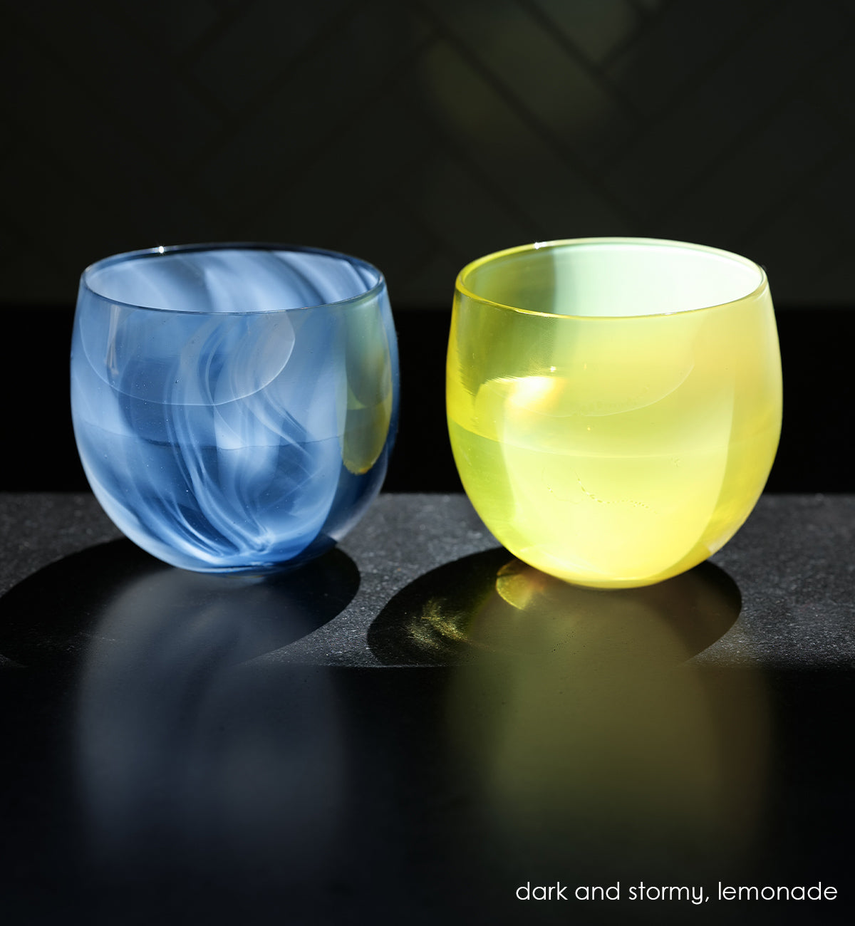 dark and stormy deep blue and white swirled together, to create this one-of-a-kind hand-blown glass. Paired with our vibrant yellow lemonade hand-blown drinking glass.
