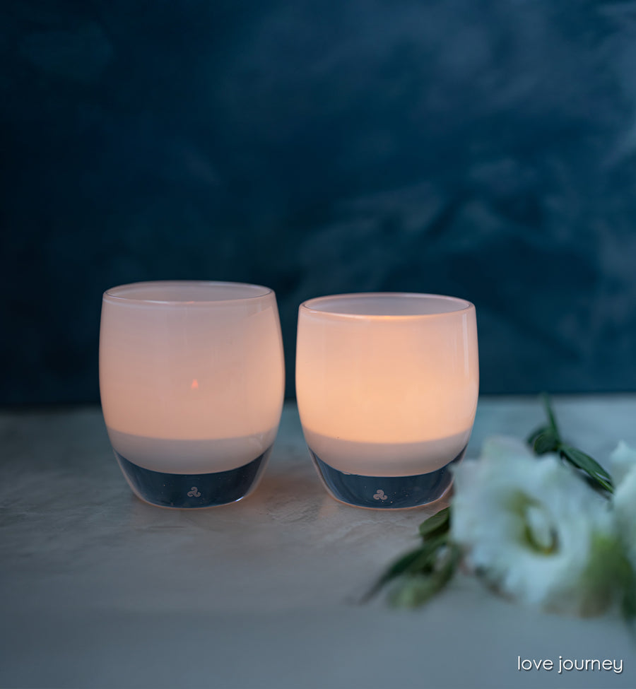love journey set includes a cherish and a celebrate glassybaby. white lit hand-blown glass candle holders.