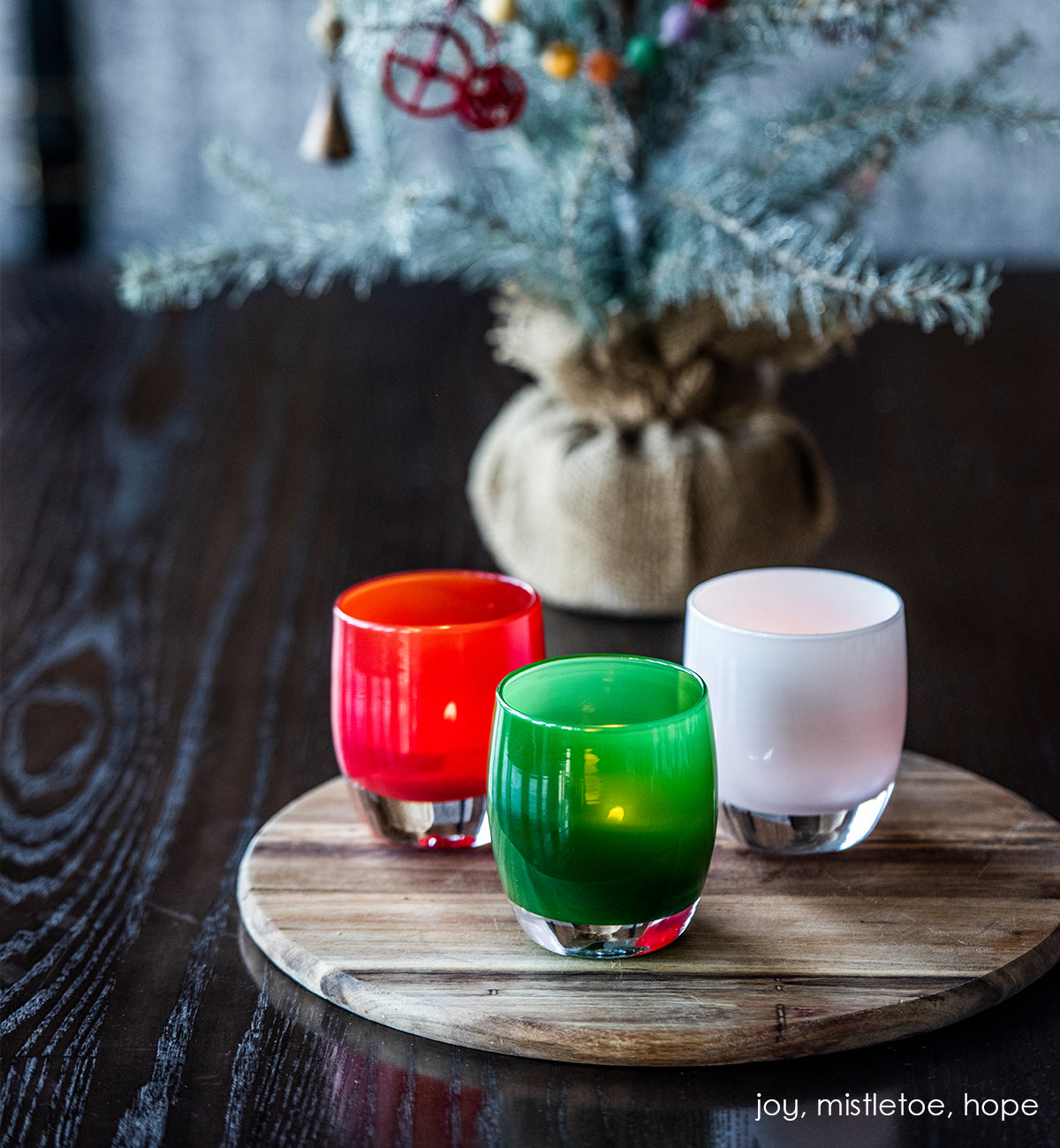 mistletoe green hand-blown glass votive candle holder. Paired with joy and hope.