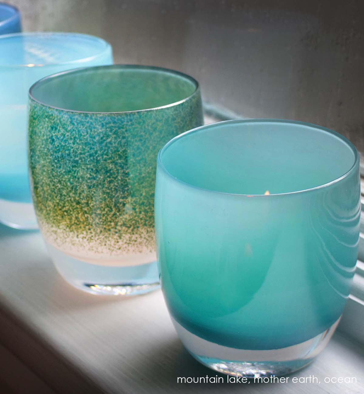mountain lake blue hand-blown glass votive candle holder. Paired with mother earth and ocean.