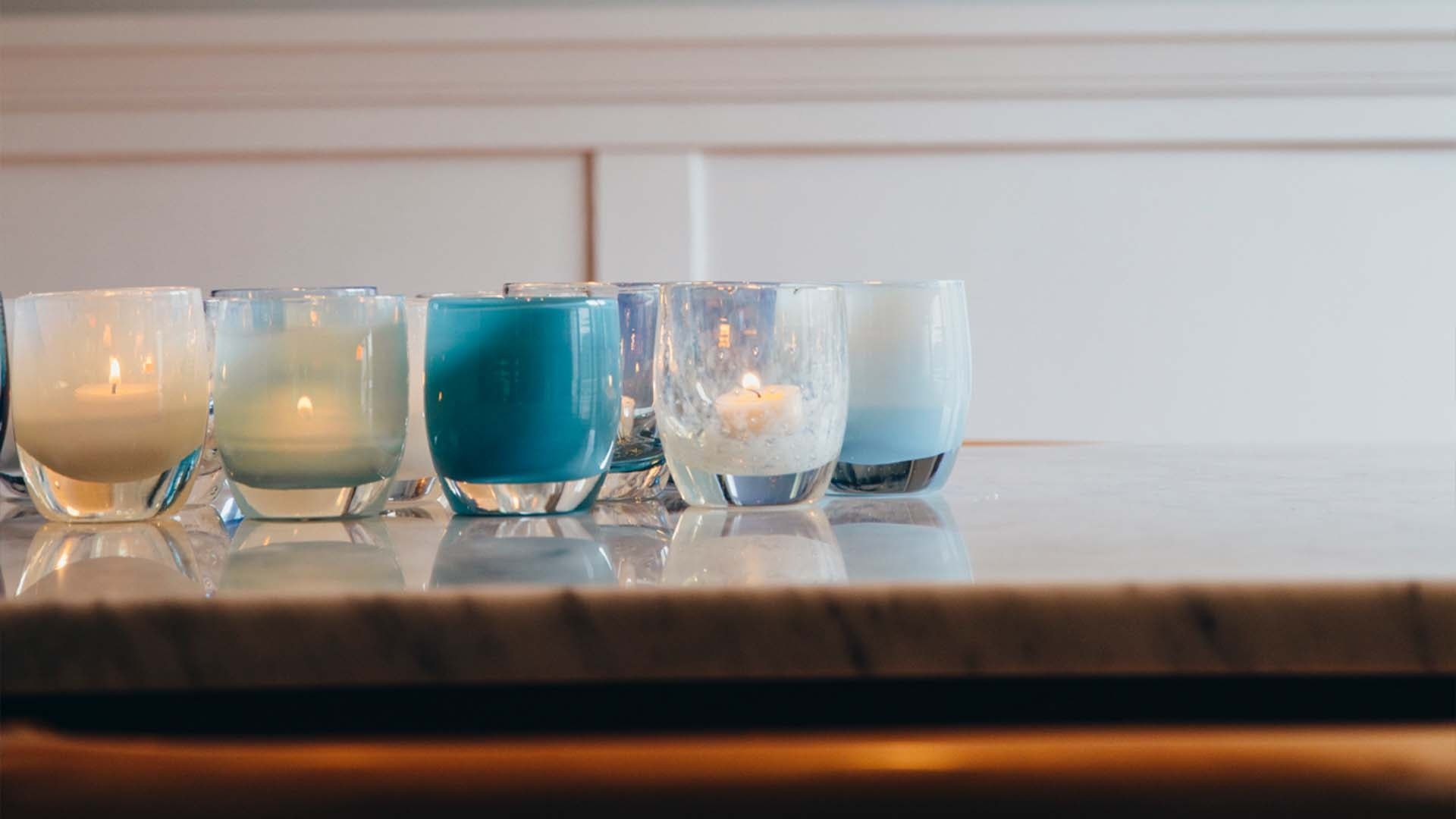 mountain lake blue hand-blown glass votive candle holder, paired with yes, celebrate, and ocean.