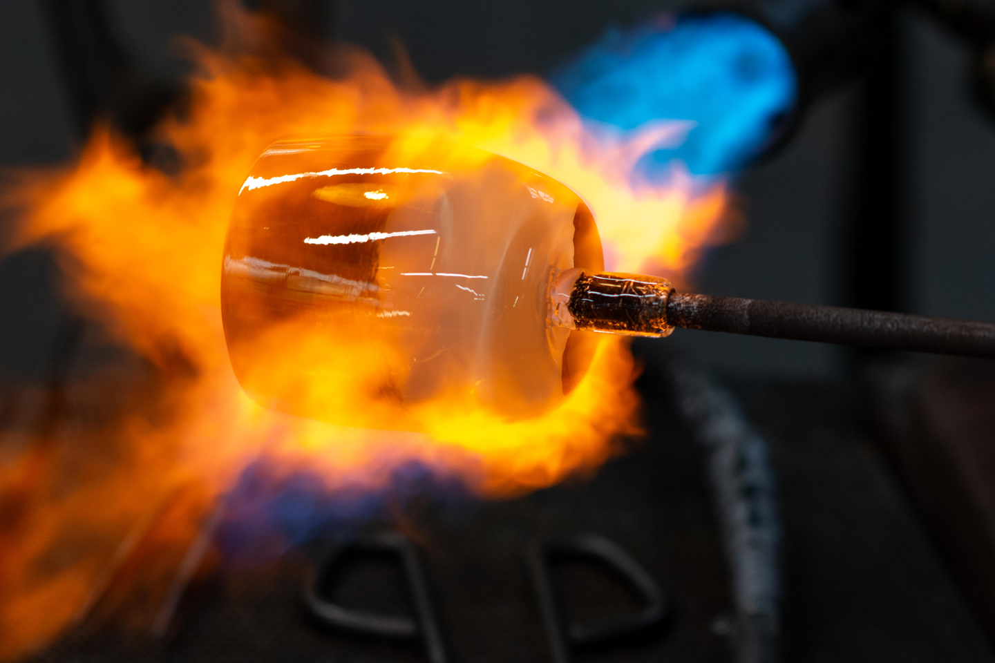 grace gold and white hand-blown glass votive candle holder being fired on pike