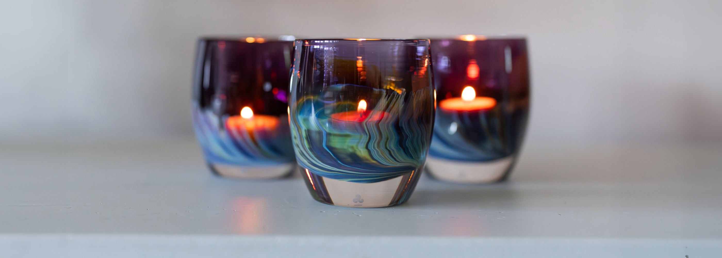 three northern lights | purple with blue and green swooshing up from the bottom hand-blown glass votive 