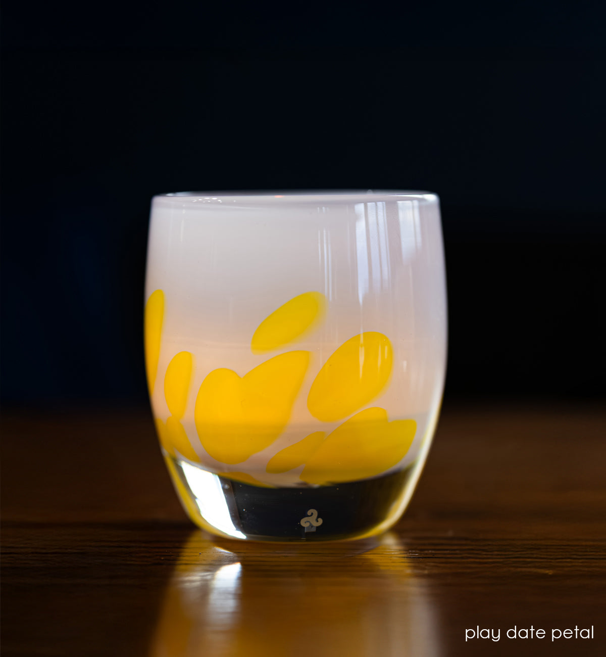 light blue with yellow petals hand-crafted glass votive candle holder lit with dark blue background