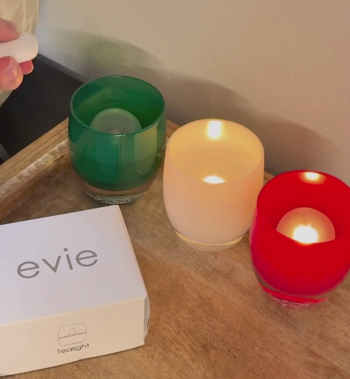 opening of the evie tealight box with ice, ice, baby on wood dresser with evie white box next to them.