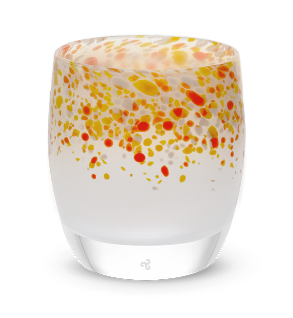 saturday red and orange frit topped white hand-blown glass votive candle holder.