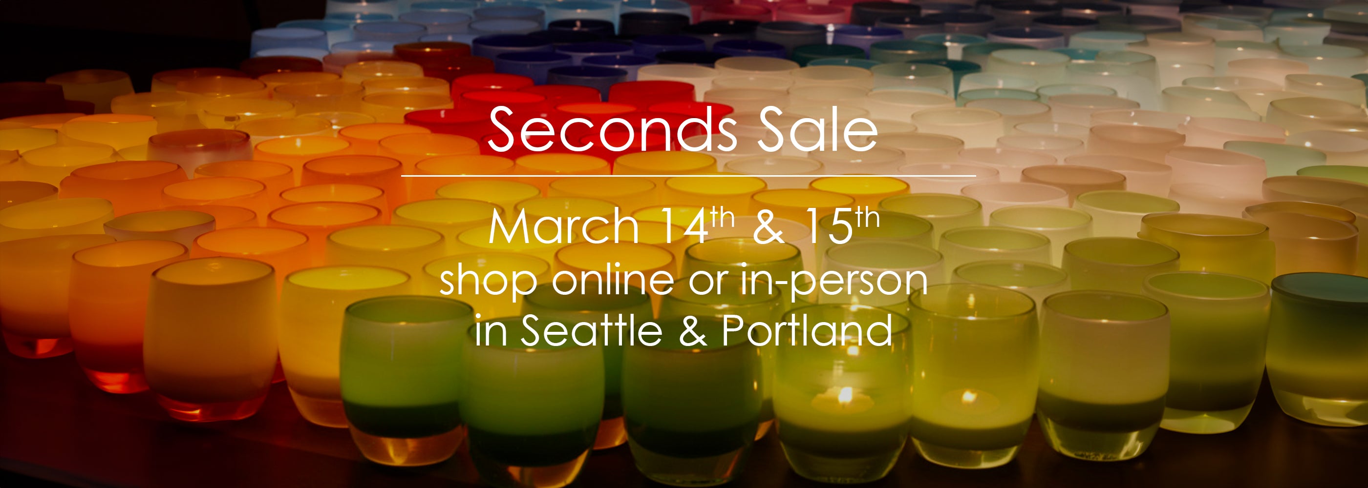 Colorful candles on a table with text about a Seconds Sale event in Seattle and Portland.