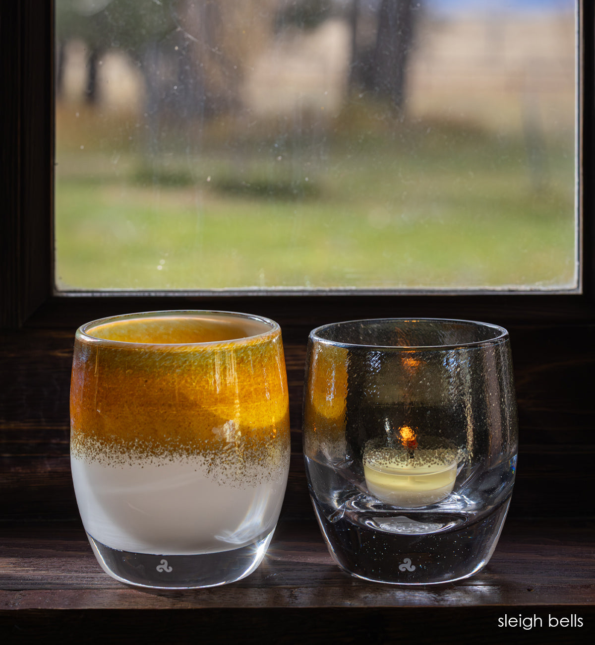 sleigh bells set, silver lining silver on clear, grace gold on white, hand-blown glass votive candle holders in windowsill 