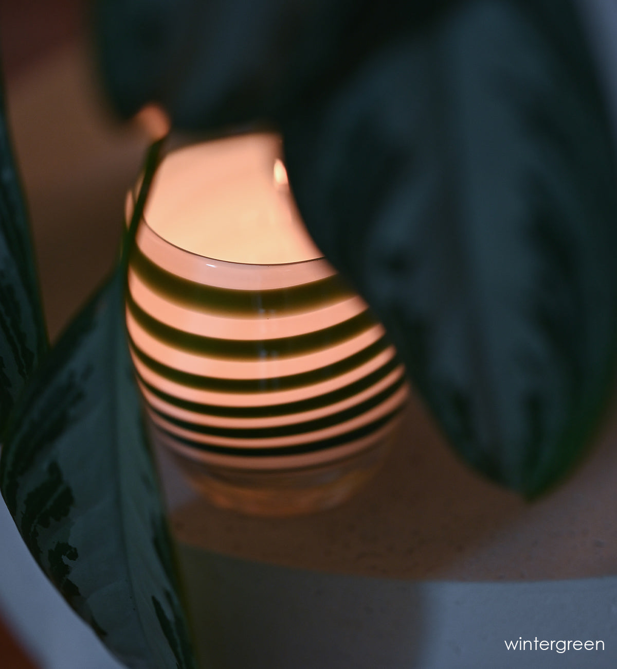 green stripes on a white base create beautiful wintergreen, a hand-blown glass votive candle holder.