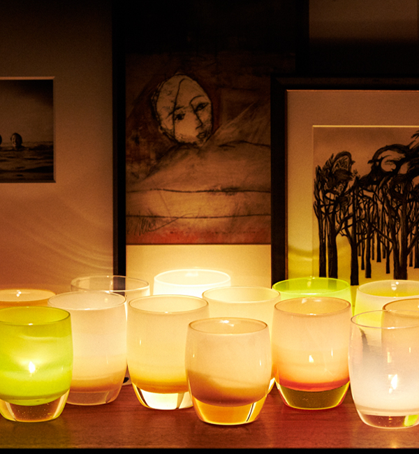 beach sandcastle tan hand-blown glass votive candle holders paired with dream, hidden moss and unconditional on a wood mantle with other art.