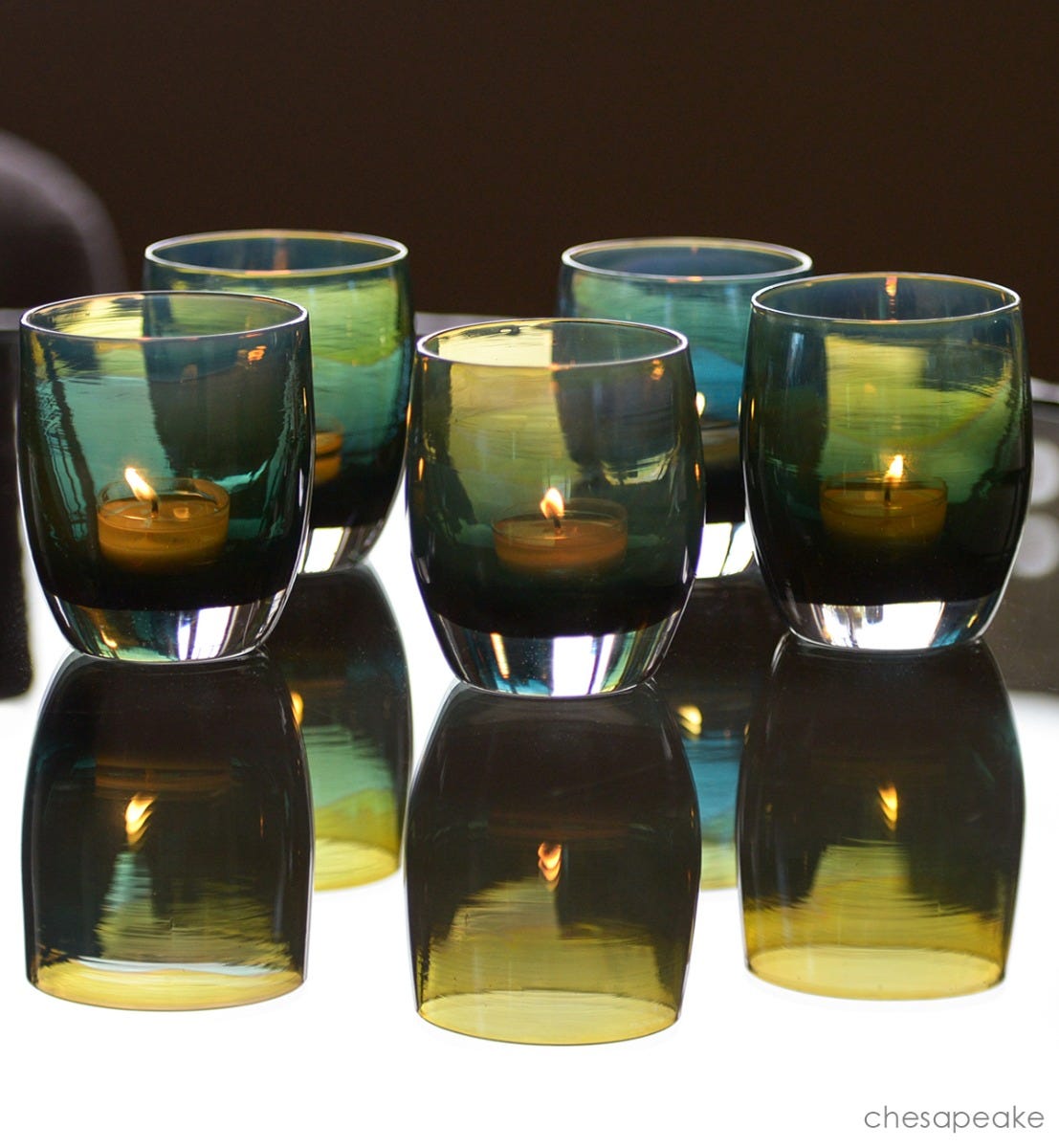 hand-blown dark green glass candle holder with touch of yellow.