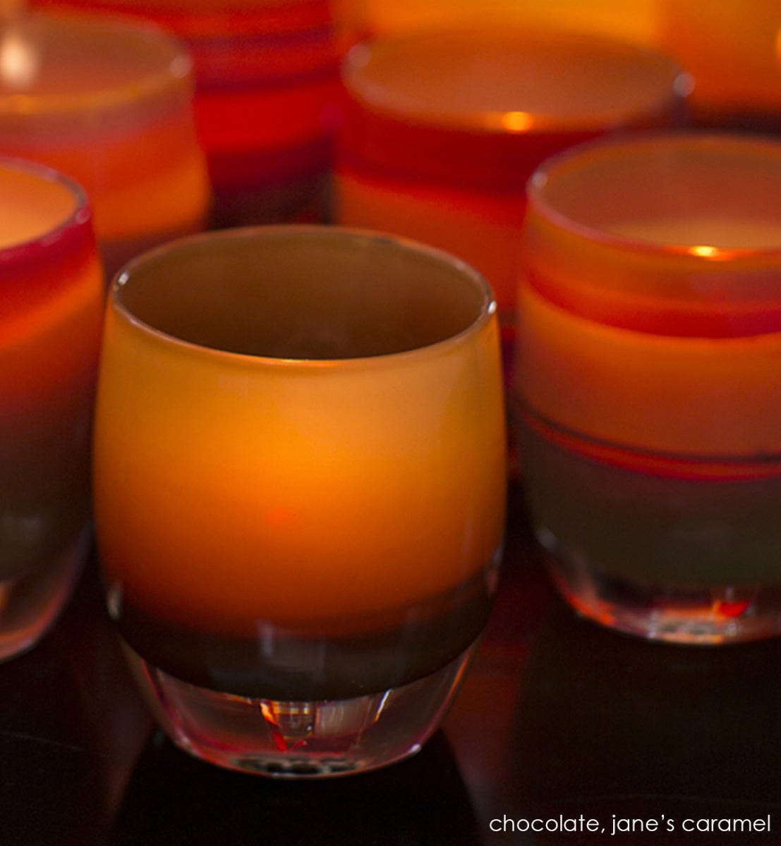 chocolate brown hand-blown glass votive candle holder. Paired with jane's caramel.