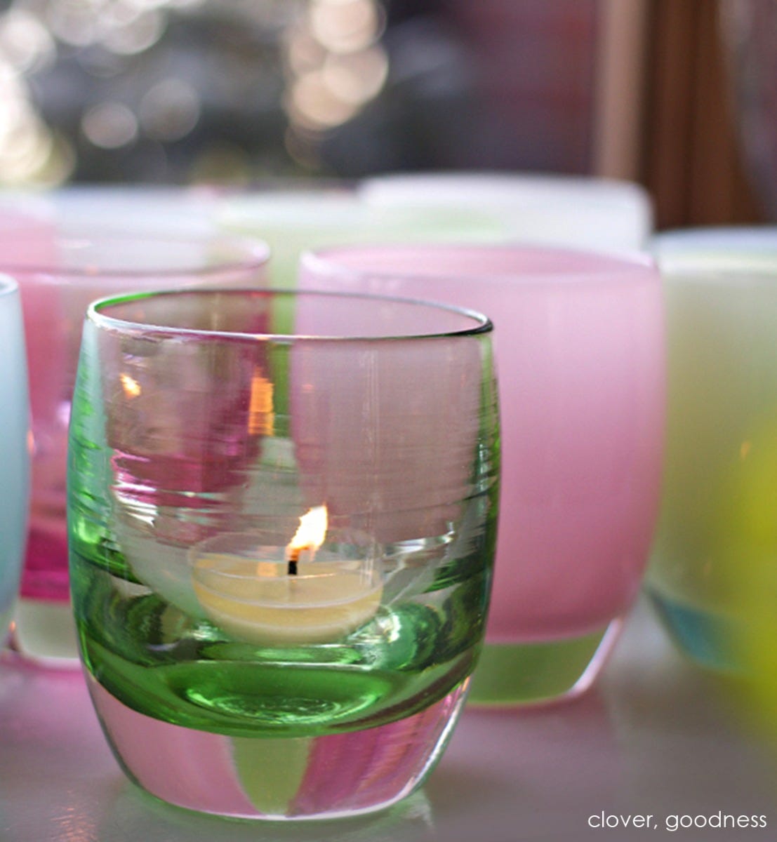 clover transparent light green hand-blown glass votive candle holder. Paired with goodness.