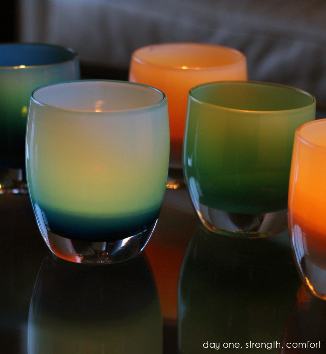 day one, bright blue with white interior, hand-blown glass votive candle holder. Paired with strength and comfort.