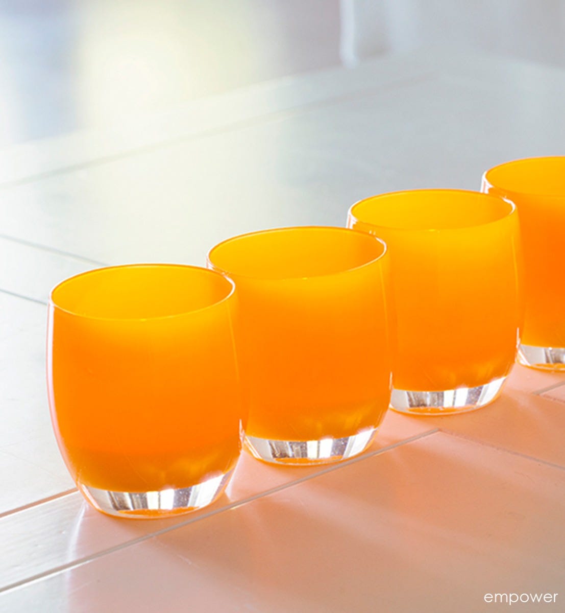 empower orange opaque, hand-blown glass votive candle holder