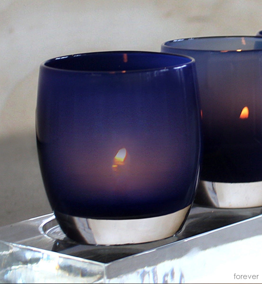 hand-blown deep ocean glass votive candle holder.