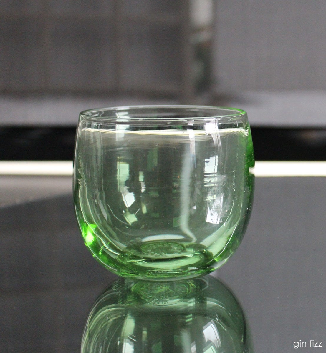 gin fizz drinker, transparent light green hand-blown drinking glass.