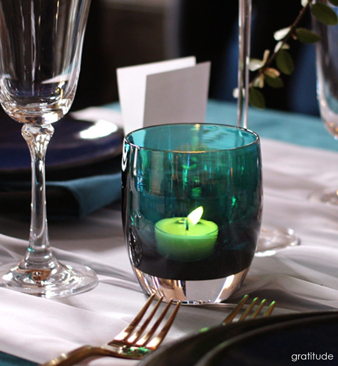 gratitude too, textured translucent teal green with silver luster, hand-blown glass votive candle holder presented with diningware.
