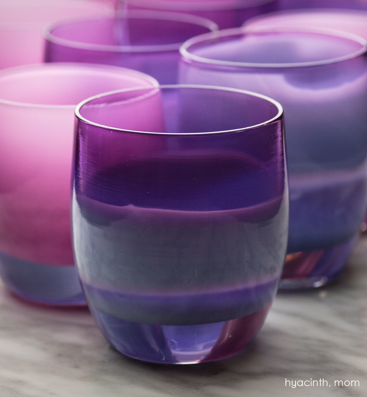 hyacinth amethyst hand-blown glass votive candle holder. Paired with mom on a wood surface.