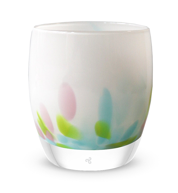 white hand-blown glass candle holder with blue, green and pink petals of color at the base.