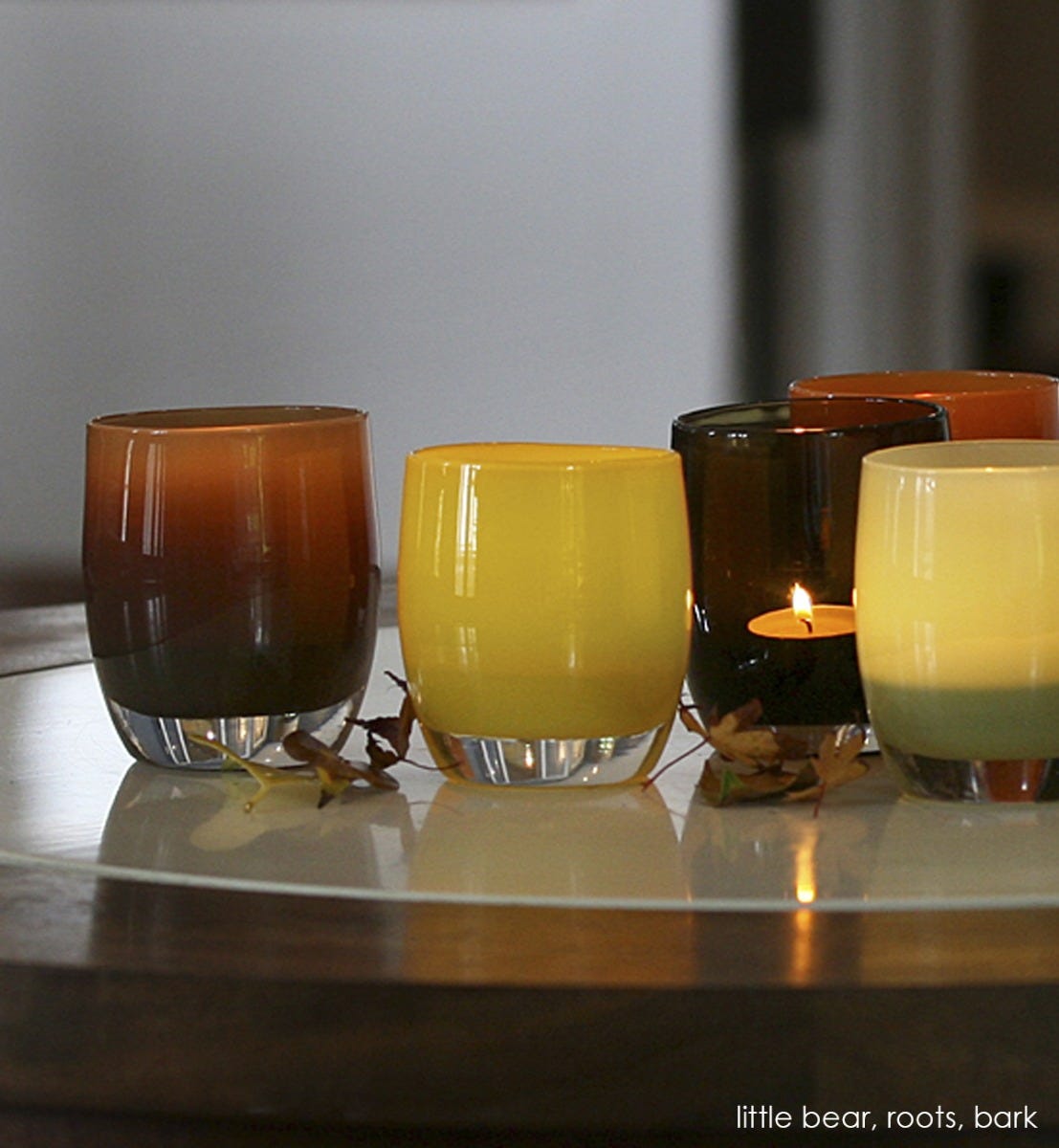 little bear deep brown hand-blown glass votive candle holder. Paired with roots and bark