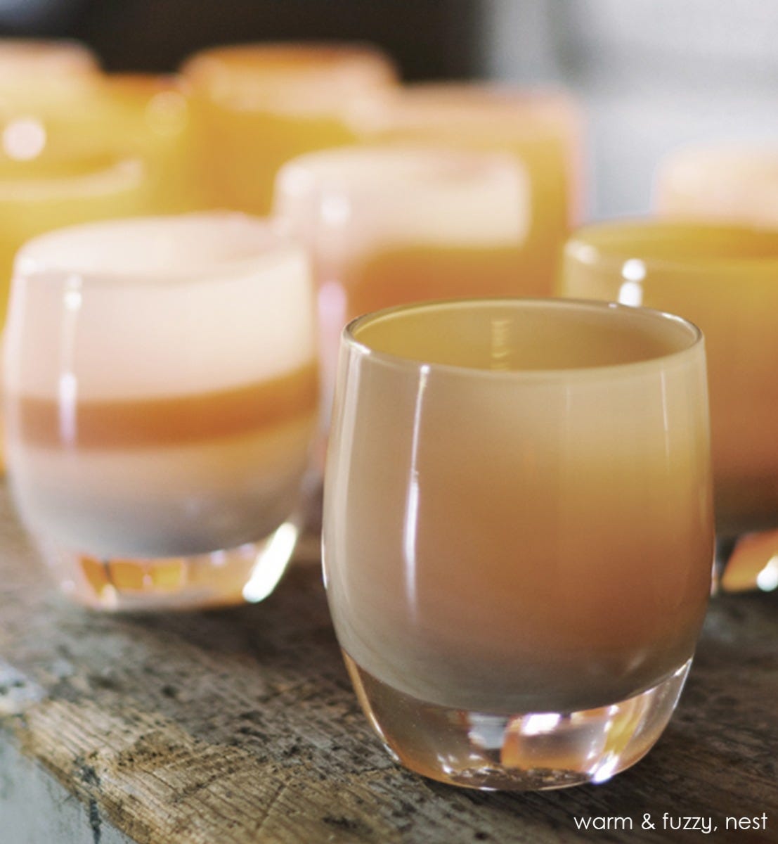 nest golden tan hand-blown glass votive candle holder. Paired with warm and fuzzy.
