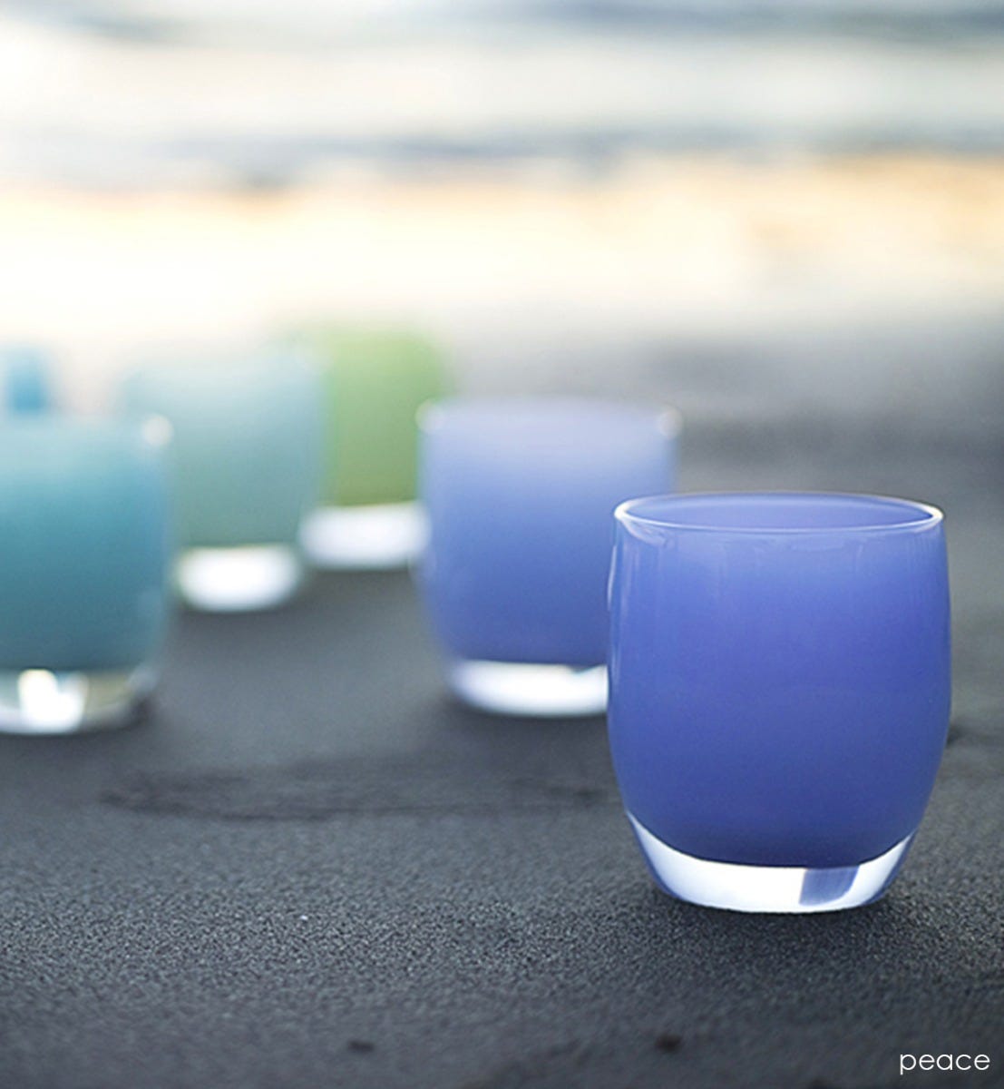 hand-blown periwinkle blue glass votive candle holder.