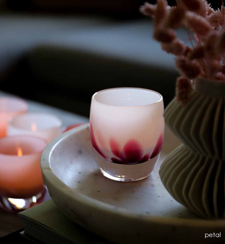 hand-blown pure daisy white glass votive candle holder.