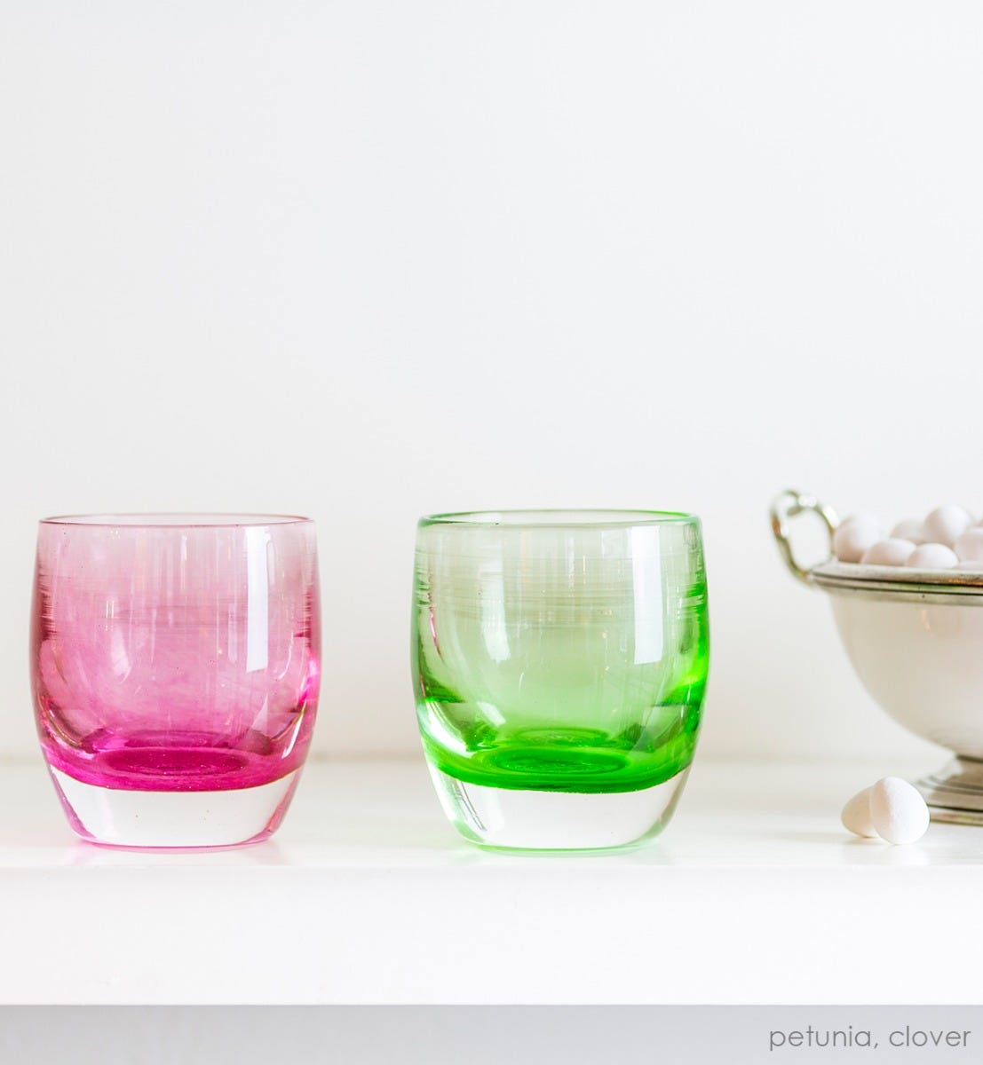 petunia transparent light pink hand-blown glass votive candle holder. Paired with clover on a white mantle.