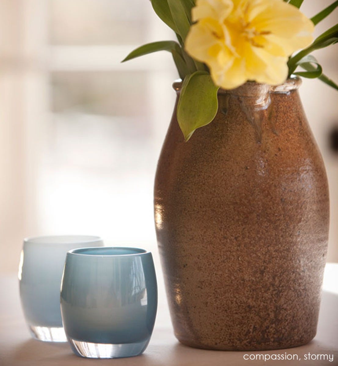 stormy blue hand-blown glass votive candle holder. Paired with compassion.