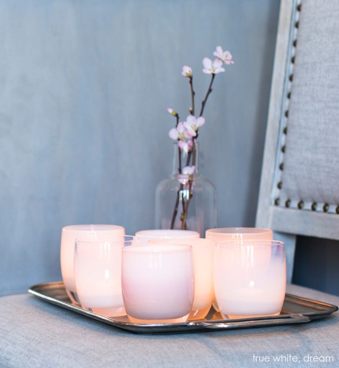 hand-blown pinky white glass votive candle holder.