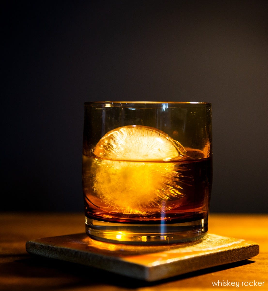 whiskey rocker, amber translucent, hand-blown glass lowball drinking glass.