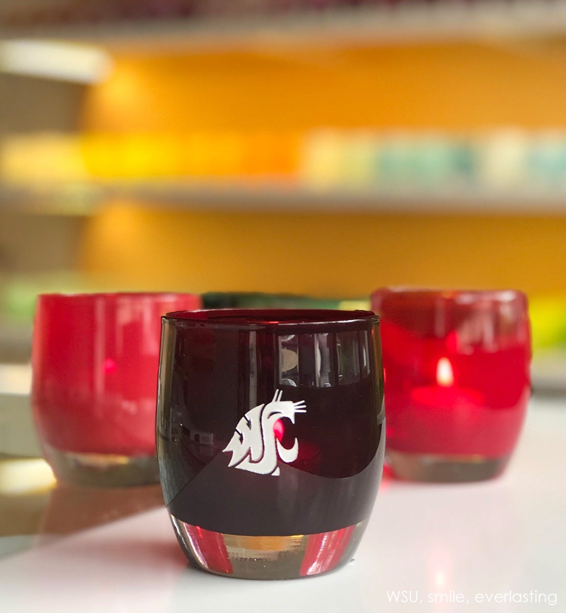 wsu, crimson with sandblasted washington state university etching hand painted in silver, hand-blown glass votive candle holder. Paired with everlasting and smile.